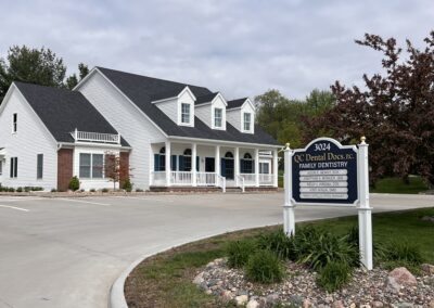 QC Dental Docs, P.C. Family Dentistry Sign up close, outside the dental office.