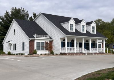 A white building with blue roof, dental office.