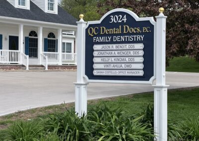QC Dental Docs, P.C. Family Dentistry Sign up close, outside the dental office.